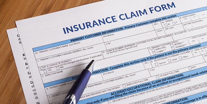 True Chiropractic filling out insurance cliam forms for patients