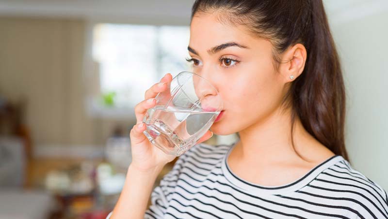 patient drinking more water following the advice of a Austin Chiropractor at True Chiropractic