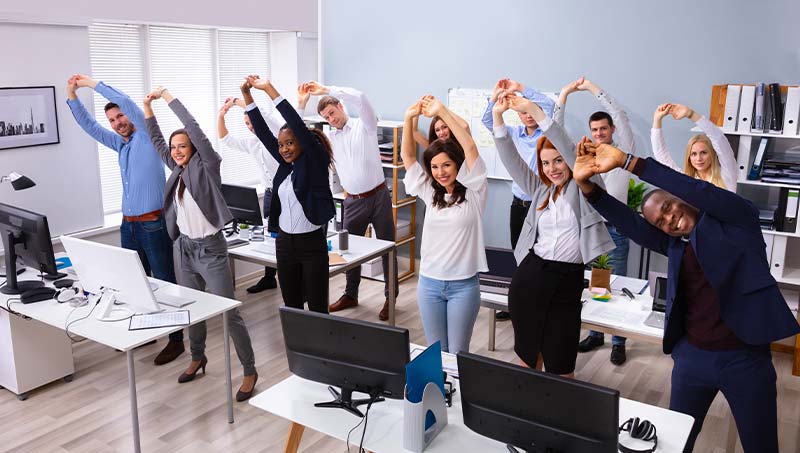 office staff stretching together following the advice of a Austin Chiropractor at True Chiropractic